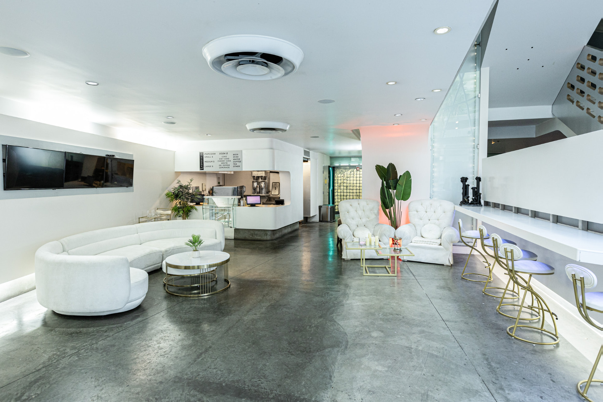 White lounge seating and bar in the ground-floor lobby of The Kult LA