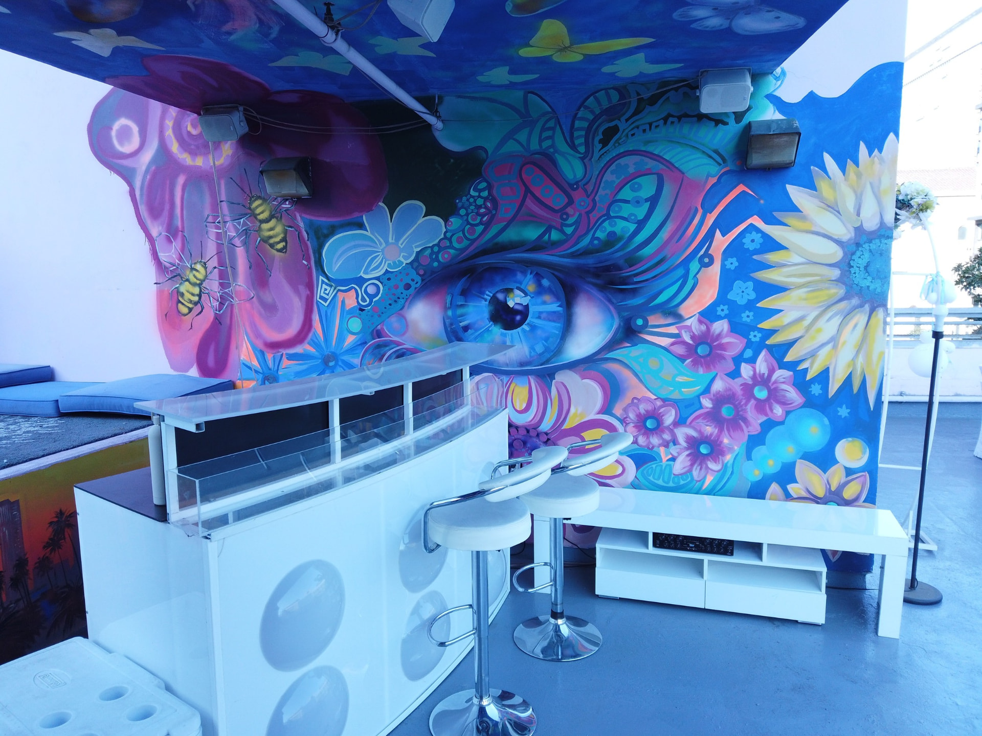 Rooftop bar against the painted mural